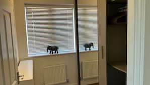 A room with a window, a radiator, and a door. - House Sleeps 8 With Wifi (Dartford)