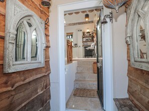 A wooden interior with a staircase leading to a kitchen area. - 7 The Cedars (Wotton-under-Edge)