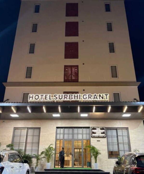 A hotel with a sign reading 'HOTELSURBHIGRANT' and a person standing at the entrance. - OPO Horizon Khatu  (Khatoo)