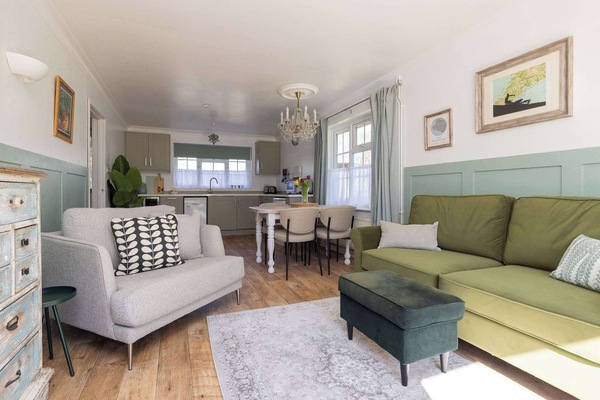 Bright open-plan living with stylish interiors, dining space and room to unwind after beach days or harbour walks.