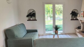 Una sala de estar con dos sofás, un televisor y una chimenea.