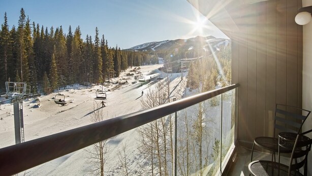 A balcony with a view of a ski slope, a chairlift, and a mountain in the distance. - Slopeside Condo w/ Chairlift Views & Pool (Breckenridge)