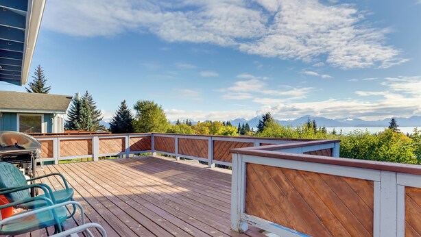 A wooden deck with a view of mountains and trees. - < 1 Mi to Pioneer Ave: Homer Base w/ Fire Pit! (Homer)