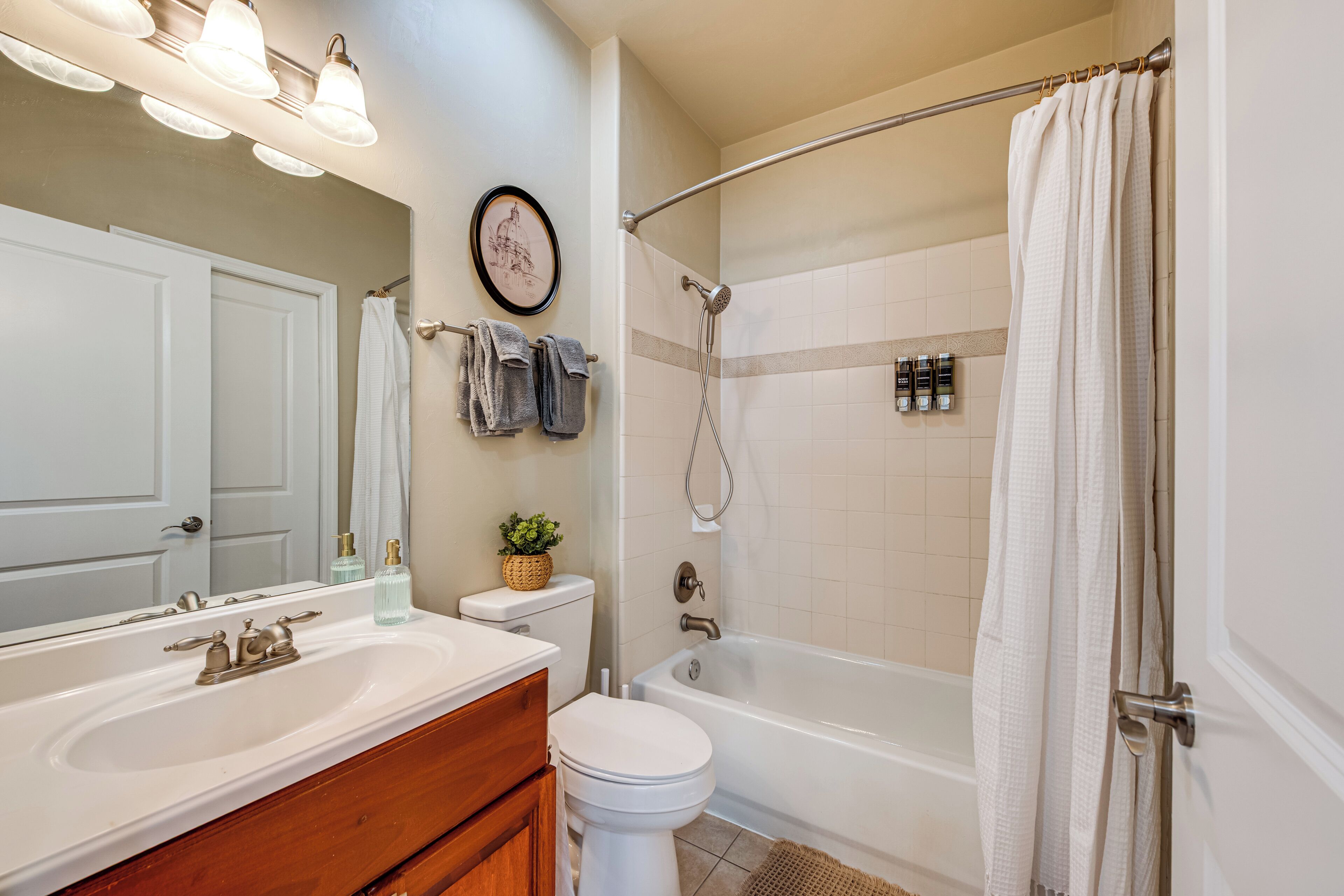 A bathroom with a sink, toilet, and bathtub.
