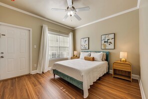 A bedroom with a bed, a ceiling fan, a window with curtains, two bedside lamps, and two wall-mounted artworks. - 3 Mi to Fsu! Pet-friendly Townhome w/ Pool Access (Tallahassee)
