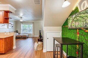 A kitchen with a wooden island, a dining area with a green textured wall, and a ceiling fan. - 3 Mi to Fsu! Townhome w/ Pool Access (Tallahassee)