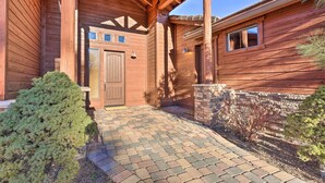 A wooden house with a brick pathway leading to the entrance. - Golfers Getaway in Show Low: Twin Townhomes! (Show Low)