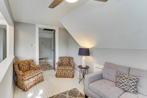 A living room with a sofa, two patterned armchairs, a lamp, and a rug. - Walkable Location! Dtwn Cary Escape w/ Fire Pit (Cary)