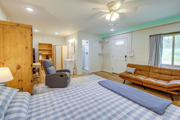 A bedroom with a bed, a sofa, a chair, a desk, and a wardrobe. - Near Greers Ferry Lake! Cabin w/ Resort Perks (Clinton)