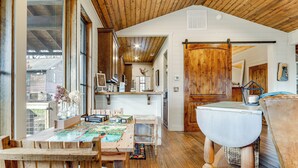A rustic interior with wooden floors, a dining table, and a large ceramic sink. - Mountain Retreat w/ Community Perks in Glenville! (Glenville)