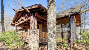 A rustic cabin with a wooden porch, stone foundation, and a large tree in the foreground. - Mountain Retreat w/ Community Perks in Glenville! (Glenville)