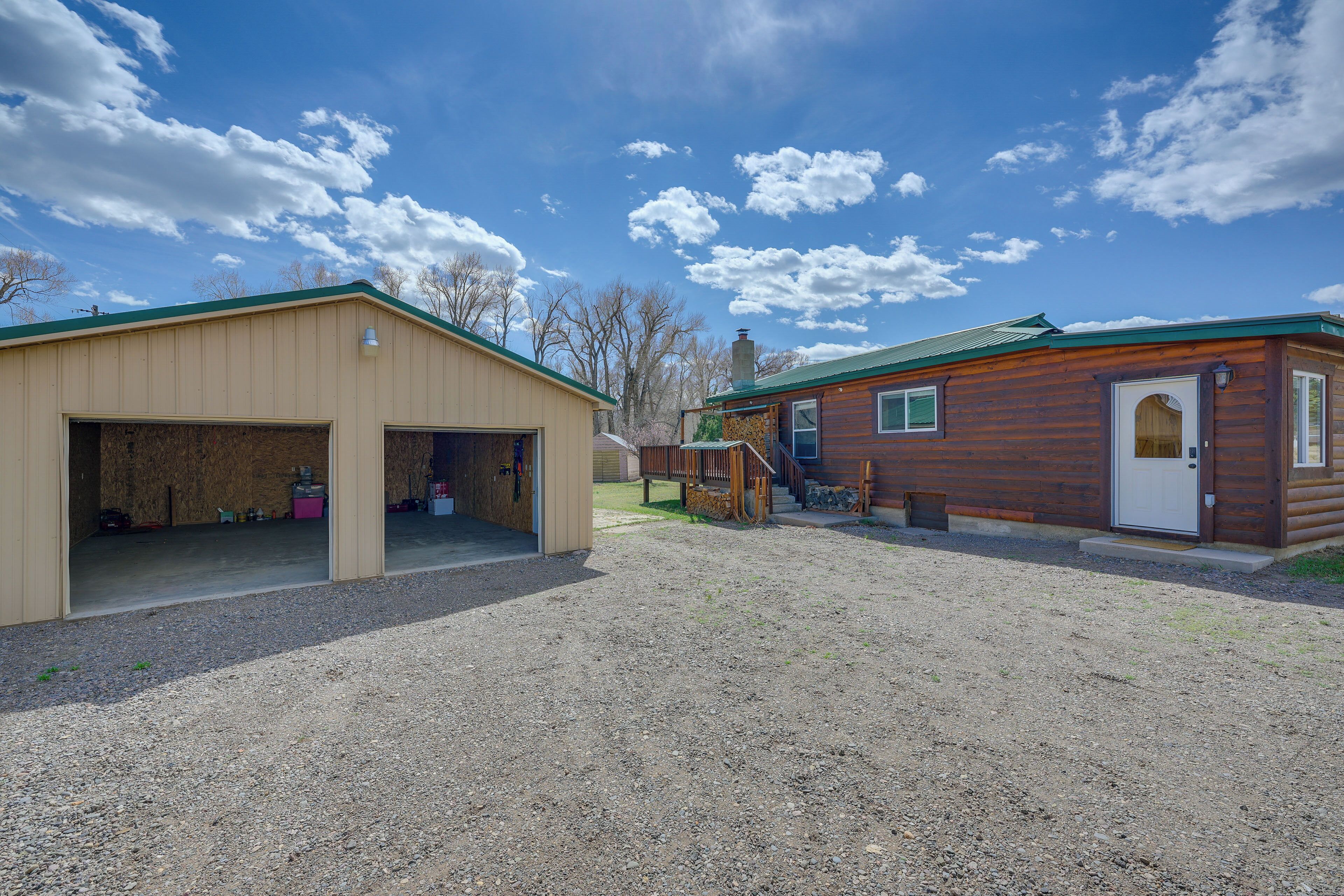 A two-story building with a garage and a wooden exterior.