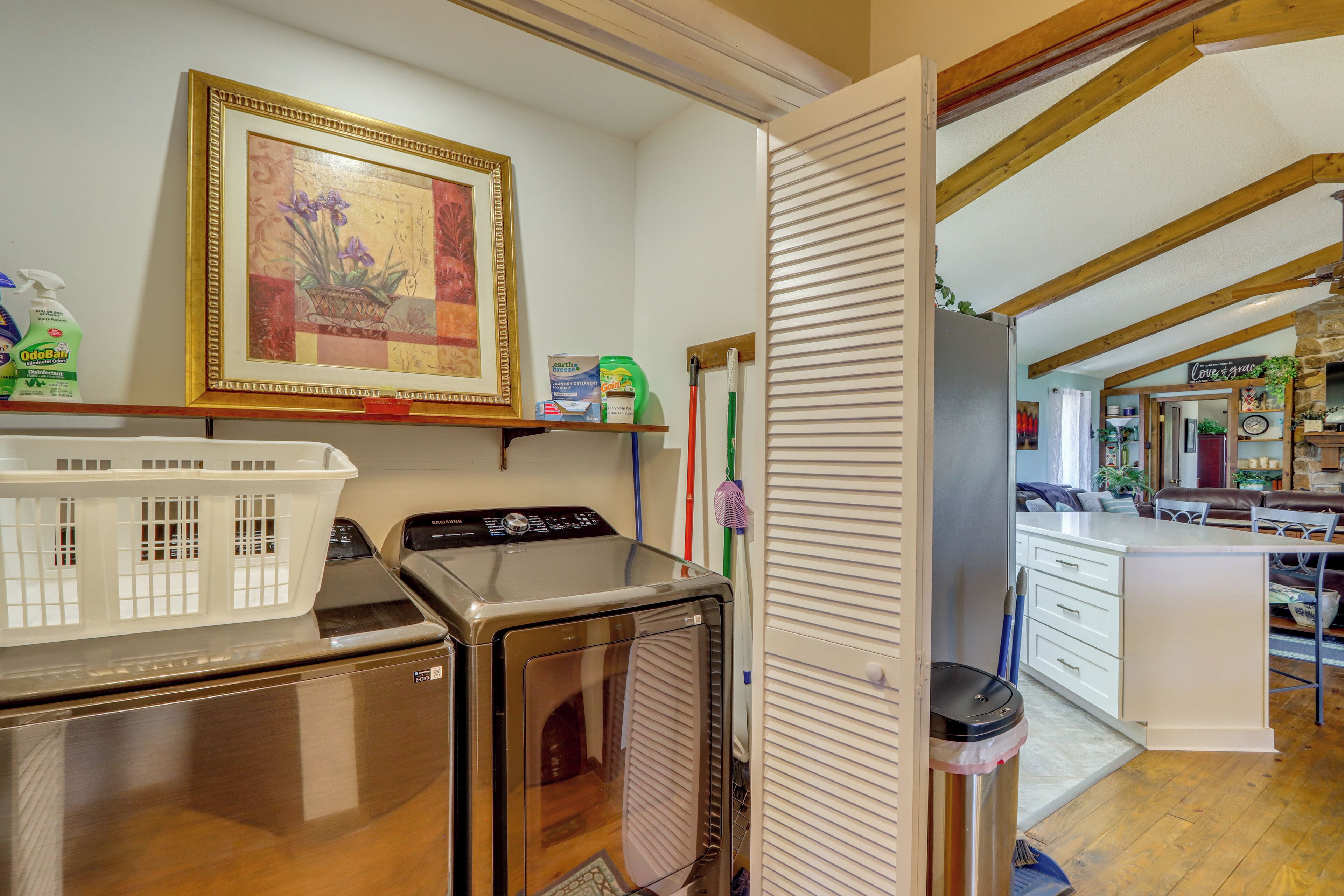 A laundry area with a washing machine, dryer, and a basket.