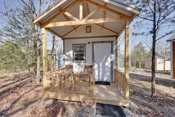 A wooden gazebo with a bench, a door, and a window. - Gem Mine & Hike! Unique Stay in Ouachita Mountains (Mena)