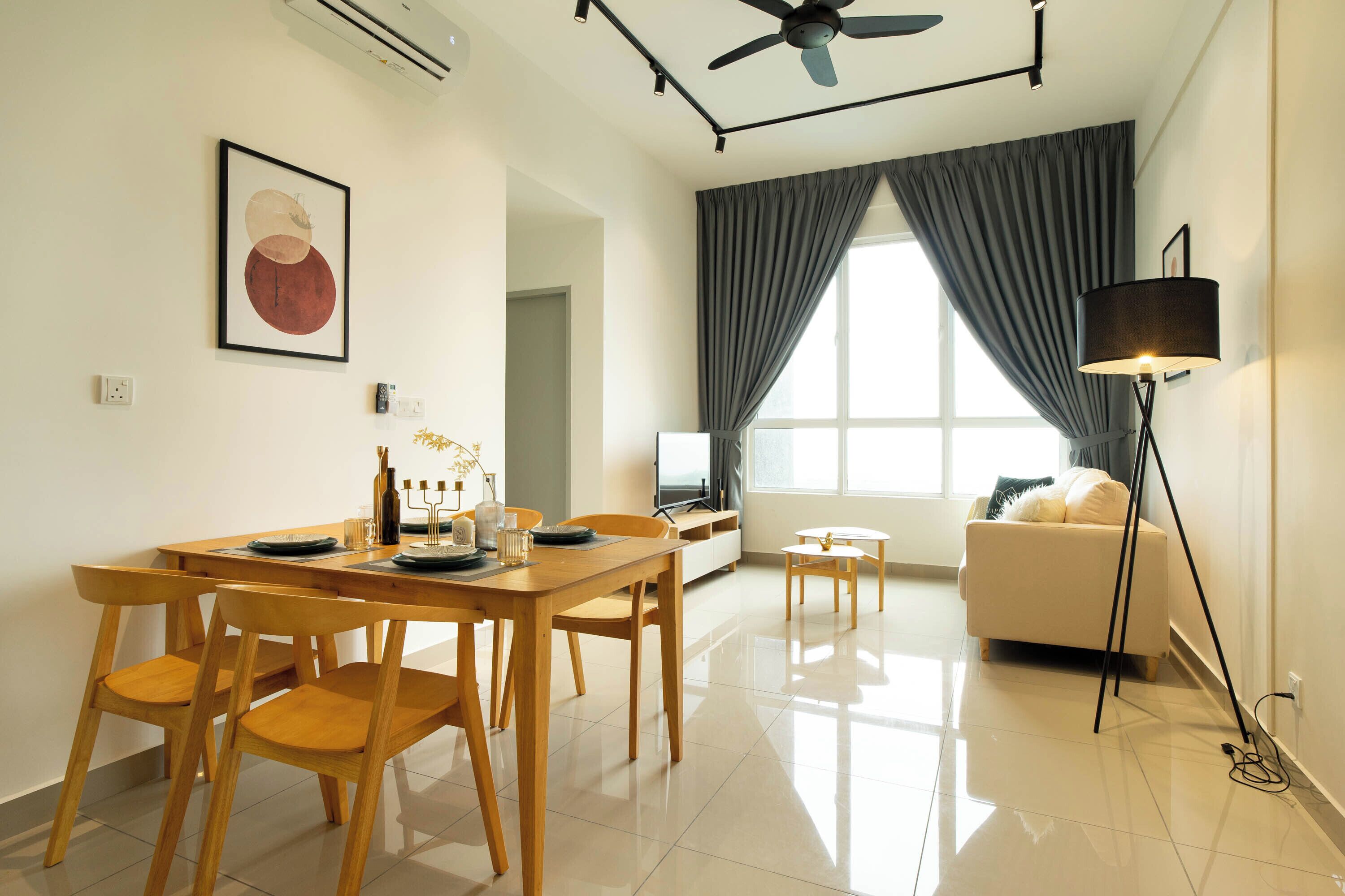 A modern living room with a dining area, a sofa, a TV, and a ceiling fan.
