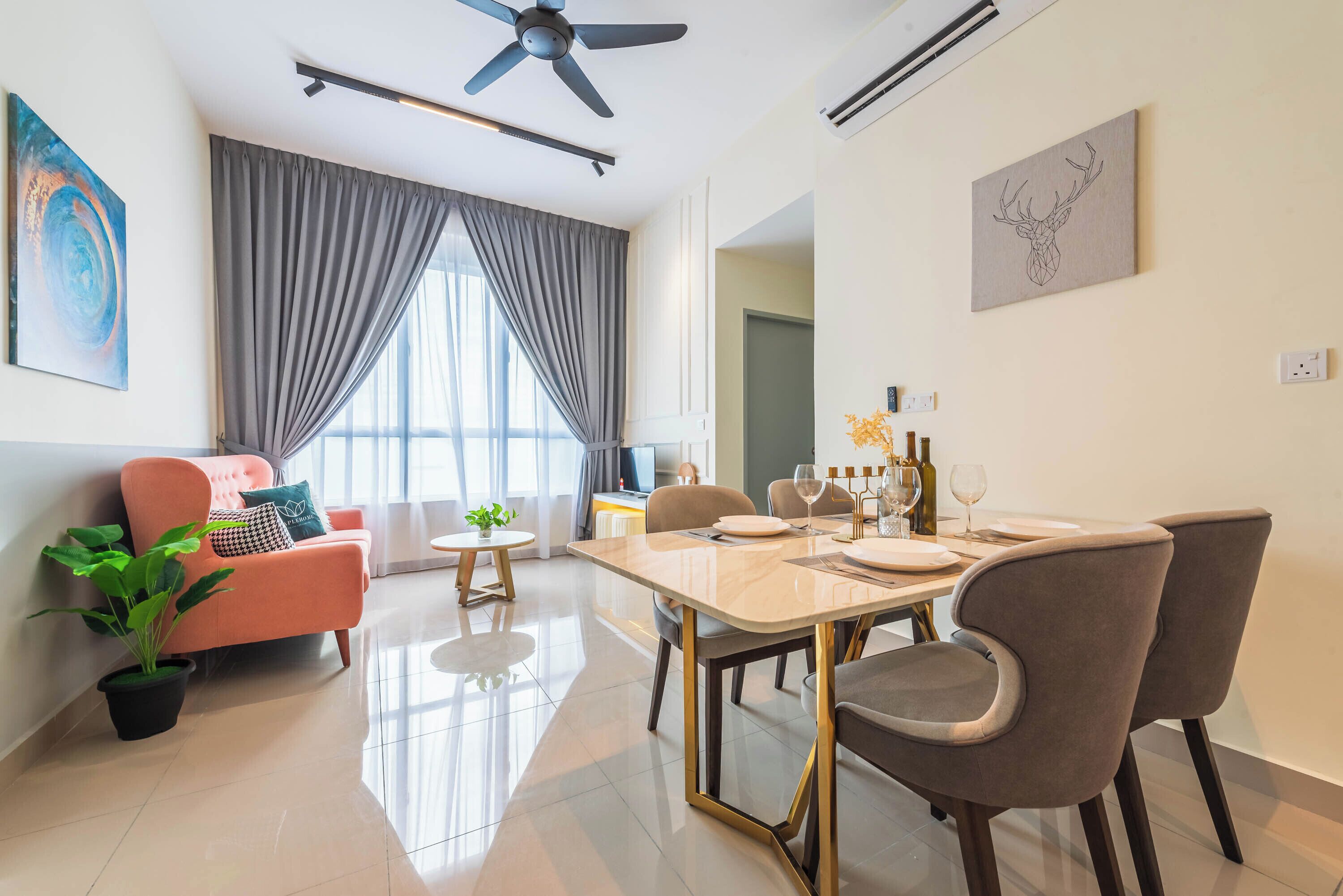 A modern living room with a dining area, a ceiling fan, and a large window with curtains.