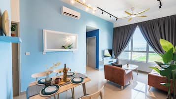 Deluxe Suite, 2 Bedrooms, Sea View | Living area | 43-inch Smart TV with digital channels