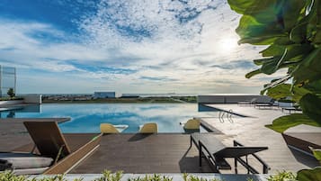 Outdoor pool, open 8:00 AM to 10:00 PM, sun loungers