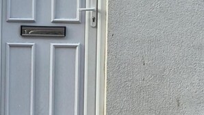 A white door with a mail slot, a doorbell, and a house number sign. - Stylish Stay in Brighton: London Road Gem (Brighton and Hove)