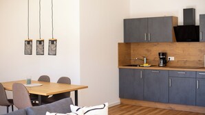 A modern kitchen with grey cabinets, a wooden countertop, and a coffee maker. - BEST STAY Rhönzauber Dietershausen (Künzell)