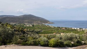 A coastal landscape with a mountain, a village, and a road. - Epidavros Villas - Elia Garden Retreat w Pool (Epidaurus)