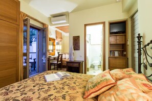 A bedroom with a bed, a desk, a chair, and a television. - Epidavros Villas - Elia Garden Retreat w Pool (Epidaurus)