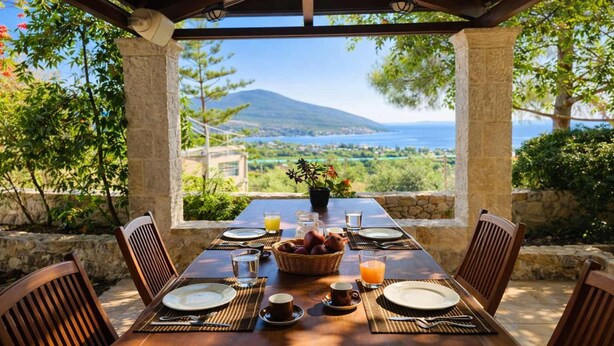 A dining table set for four with a view of a mountainous landscape and a body of water. - Epidavros Villas - Voukamvilia Retreat w Pool (Epidaurus)