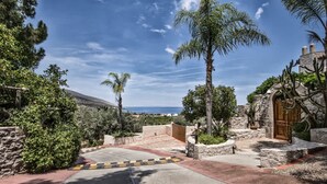 A coastal property with a paved driveway, stone walls, and a wooden gate. - Epidavros Villas - Voukamvilia Retreat w Pool (Epidaurus)
