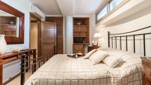 A bedroom with a bed, bedside table, lamp, and a wooden wardrobe. - Epidavros Villas - Voukamvilia Retreat w Pool (Epidaurus)