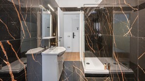 A modern bathroom with a glass shower enclosure, a white sink, and a mirror. - Mirosa Luxury Room 214 with Wi-Fi and Air Conditioning (Pompei)