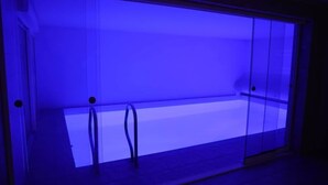 A room with a glass partition, a metal railing, and a tiled floor. - Villa with indoor pool (Holtzheim)