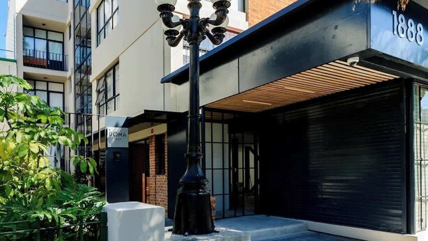 A modern building with a black awning, a street lamp, and a sign reading 'ROMA 1888'. - Apt 2BR balcony, terrace, Heart of Guadalajara (Guadalajara)