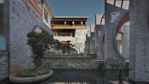 A courtyard with a reflective water feature, traditional architecture, and a central building with a balcony. - Arcadia Yunjinyue Hotel (Dali)