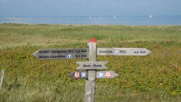 A directional signpost with multiple arrows pointing towards various destinations, including distances in kilometers.