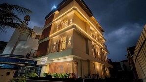 A multi-story hotel with balconies, a sign reading 'Aywa Hotel,' and a prominent 'A' sign on the roof. - AYWA Hotels (Kanayannur)