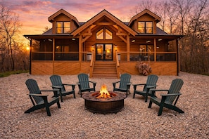 A log cabin with a fire pit and outdoor seating.