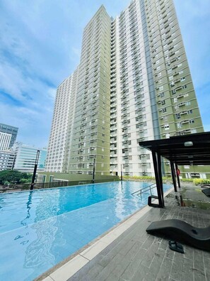 A high-rise residential building with a swimming pool in the foreground. - Modern Comfort at Avida Towers Riala (Cebu City)