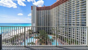 A high-rise hotel with multiple balconies, a pool area, and a beach view. - 🌊Large Balcony-Gulf Views-Multiple Pools-Shores of Panama 925🌊 (Panama City Beach)