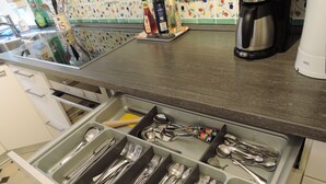 A kitchen with a drawer organizer for utensils, a coffee maker, and a kettle. - Historic wine farmhouse in Main/Wine Franconia at the foot of the Spessart (Triefenstein)