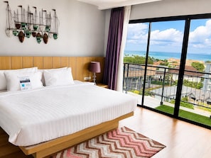 A hotel room with a large bed, a view of the sea, and a balcony. - Luxurious Penthouse 3-bedroom Stunning Seaview Apartment in Ao Nang, Thailand (Krabi)