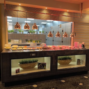 A buffet area with a variety of food items, hanging pendant lights, and potted plants. - Relaxing Stay with On-site Restaurant, Pool, Free Parking, & Peaceful Atmosphere (Zeist)