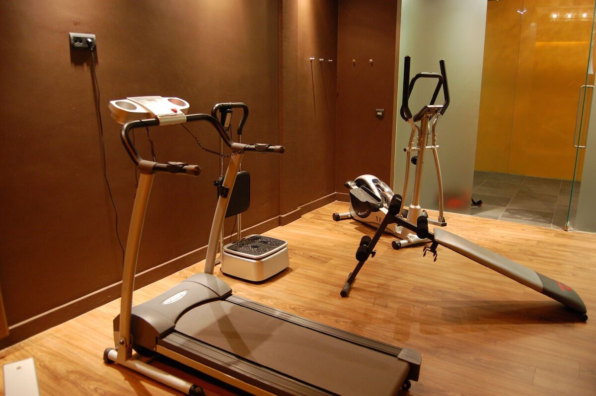 Area fitness con attrezzature, tra cui tapis roulant, ellittica e cyclette.