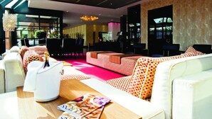 A lobby with a red carpet, seating areas, a reception desk, and a chandelier. - Relaxing Stay with On-site Restaurant, Free Parking, and Peaceful Atmosphere (Zeist)