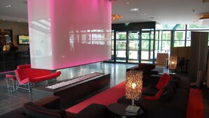 A modern lobby with a large digital screen, comfortable seating areas, and a reception desk. - Relaxing Stay with On-site Restaurant, Free Parking, and Peaceful Atmosphere (Zeist)