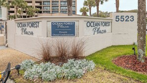 Ein Gebäude mit Balkonen und einem Schild für Ocean Forest Plaza.