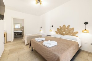 A hotel room with two beds, a bathroom, and a view of the hallway. - Masseria Coccolo (Carovigno)