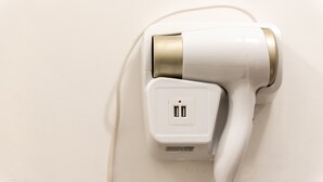 A hair dryer plugged into a wall socket. - Holiday House Annunziata 1 Apartment with Wi-Fi and Air Conditioning (Termini Imerese)