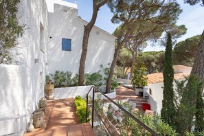 A white building with a blue window, a staircase, and surrounding trees. - Villa with Pool 800 Meters from Playa de Pals (Pals)