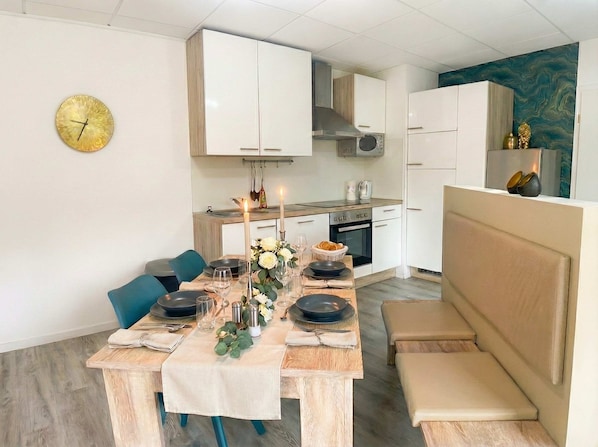 A modern kitchen with white cabinets, a microwave, and a stove.