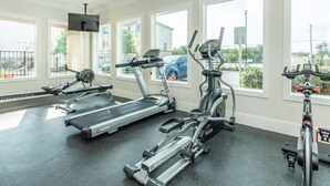 A gym with treadmills, ellipticals, and a stationary bike. - 1bhk Furnished Retreat Cedar Park Austin Stay (Cedar Park)